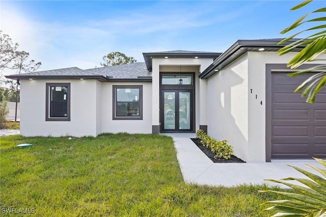 property entrance featuring french doors, a yard, and a garage