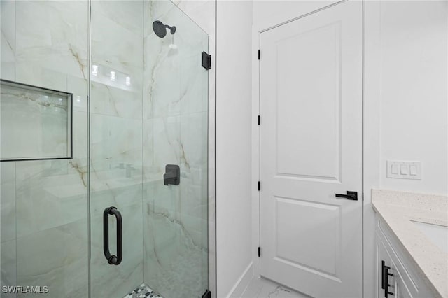 bathroom featuring vanity and a shower with shower door