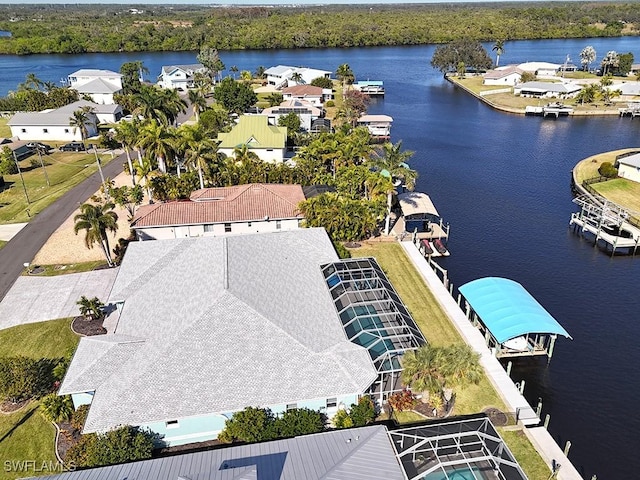 drone / aerial view featuring a water view and a residential view