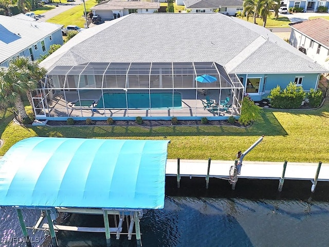 back of property with a lanai, a water view, a yard, an outdoor pool, and a patio area