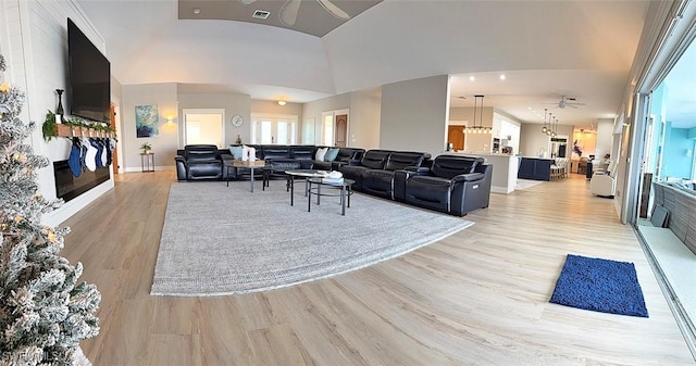 living room featuring light wood-type flooring and ceiling fan