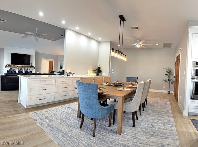 dining area with ceiling fan and light wood-type flooring