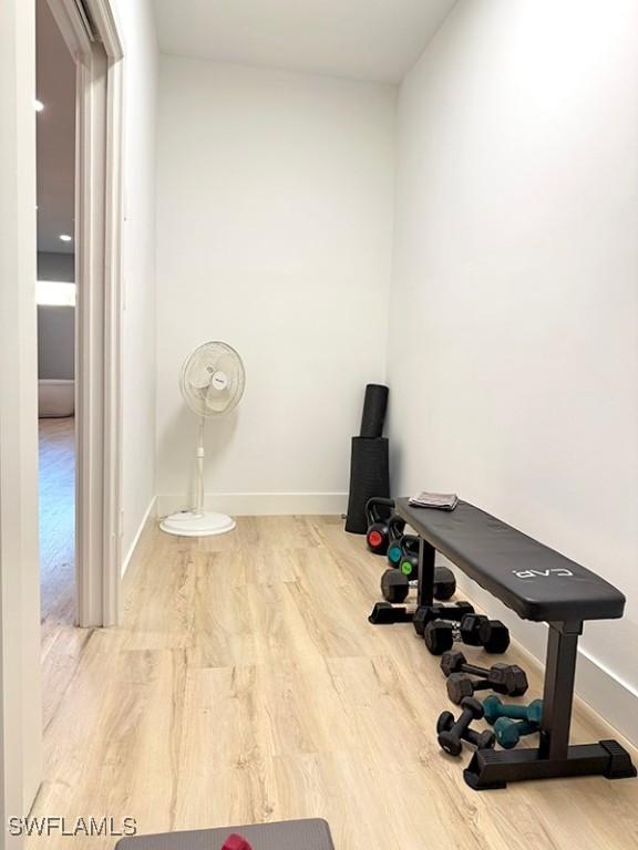 exercise room featuring wood finished floors and baseboards