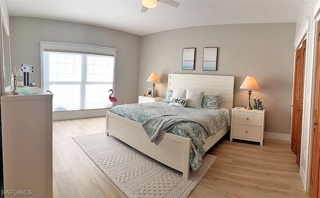 bedroom with ceiling fan and light wood-type flooring