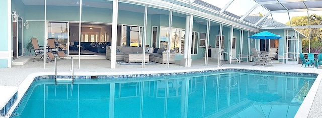 view of pool featuring outdoor lounge area, glass enclosure, and a patio area