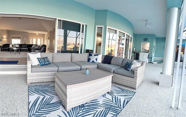 living room featuring ceiling fan, carpet, and vaulted ceiling