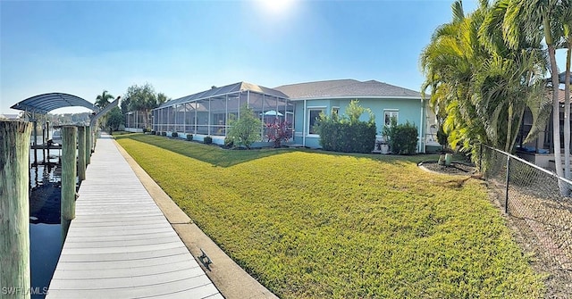 exterior space featuring a lanai, stucco siding, fence, and a yard