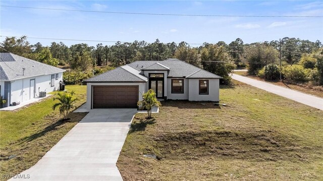 view of front of property with a front yard and a garage