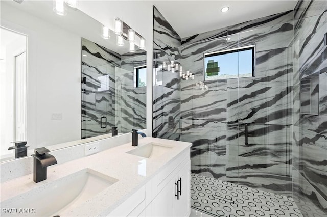 bathroom featuring vanity and a shower with shower door