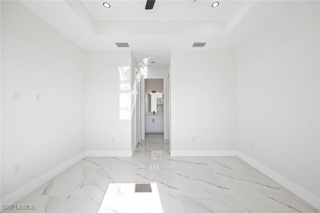 spare room with a tray ceiling