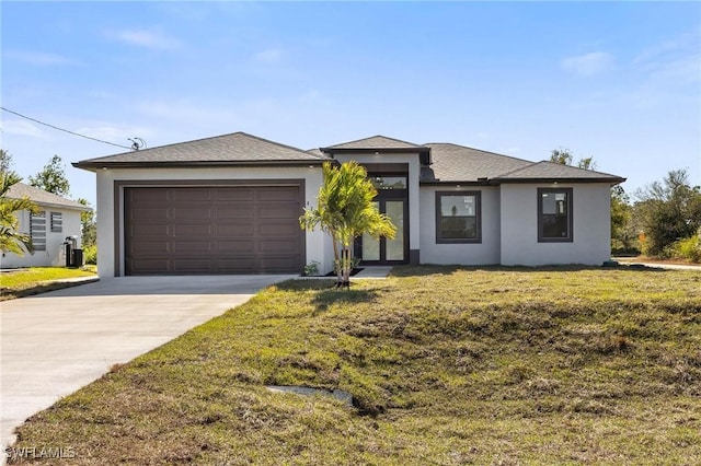 view of front of property with a garage and a front yard