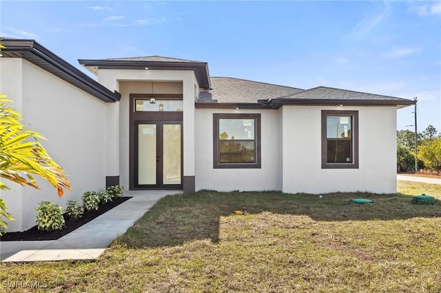 entrance to property featuring a yard