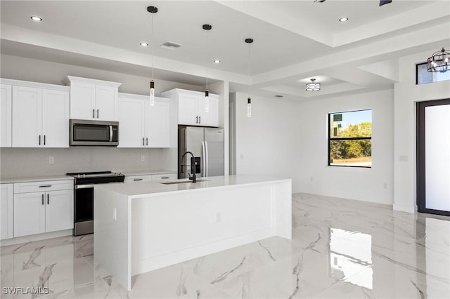 kitchen featuring sink, an island with sink, pendant lighting, white cabinets, and appliances with stainless steel finishes