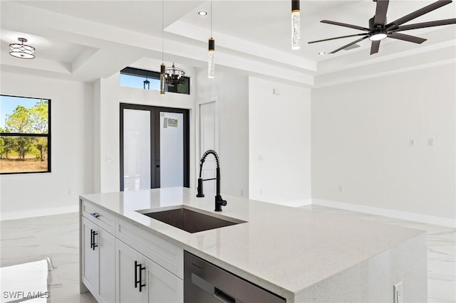 kitchen featuring light stone countertops, white cabinets, a tray ceiling, decorative light fixtures, and dishwasher