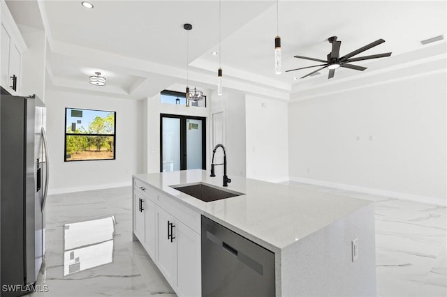 kitchen featuring a kitchen island with sink, white cabinetry, light stone countertops, and stainless steel appliances