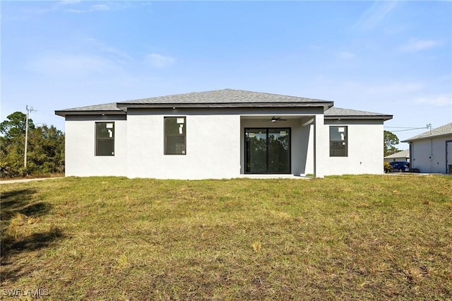 back of house with a yard and ceiling fan