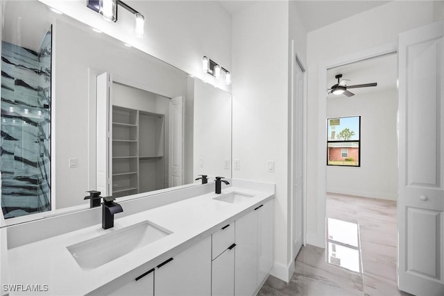 bathroom featuring ceiling fan, vanity, and walk in shower