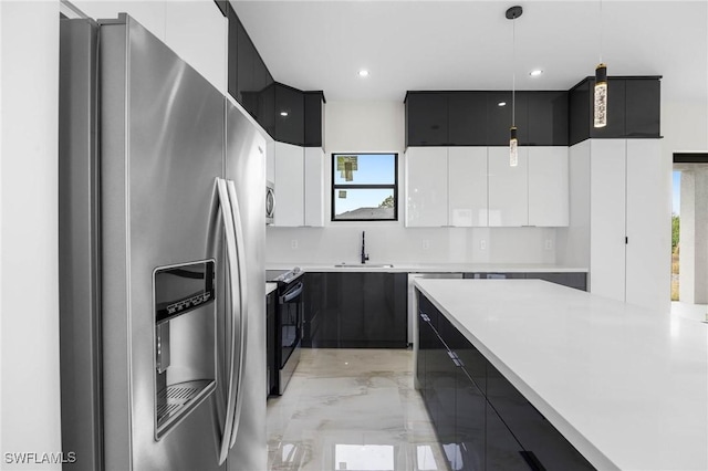 kitchen featuring white cabinetry, sink, hanging light fixtures, decorative backsplash, and appliances with stainless steel finishes