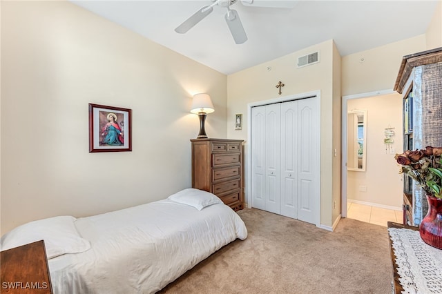 bedroom with light colored carpet, a closet, and ceiling fan