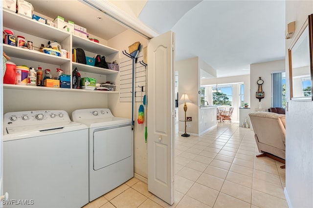 laundry area with light tile patterned flooring and independent washer and dryer