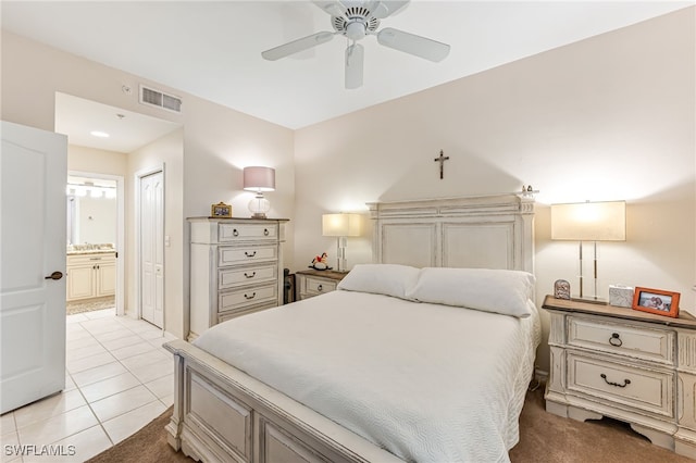 bedroom featuring connected bathroom, ceiling fan, and light tile patterned flooring