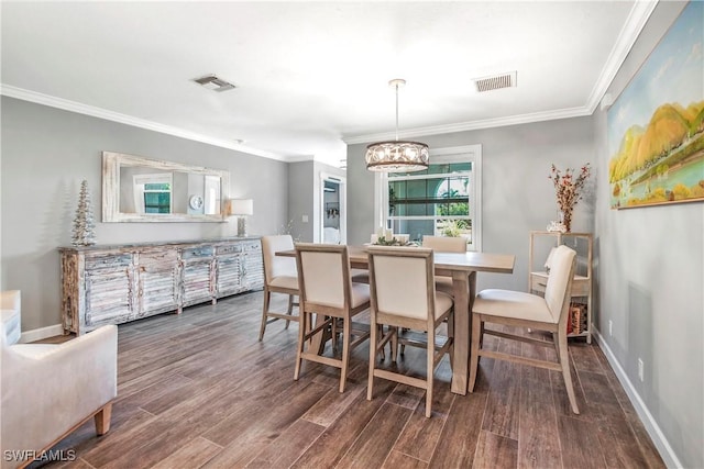 dining space with hardwood / wood-style floors, a notable chandelier, and ornamental molding