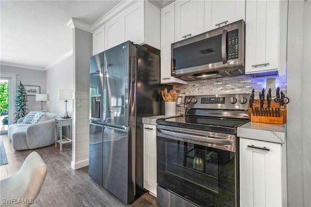 kitchen with white cabinets, crown molding, appliances with stainless steel finishes, and dark wood-type flooring