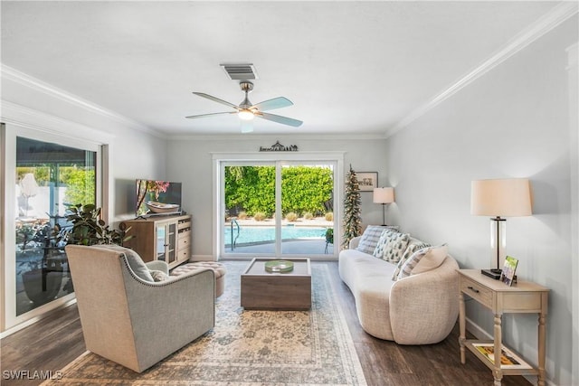 living room with ceiling fan, dark wood-type flooring, and ornamental molding