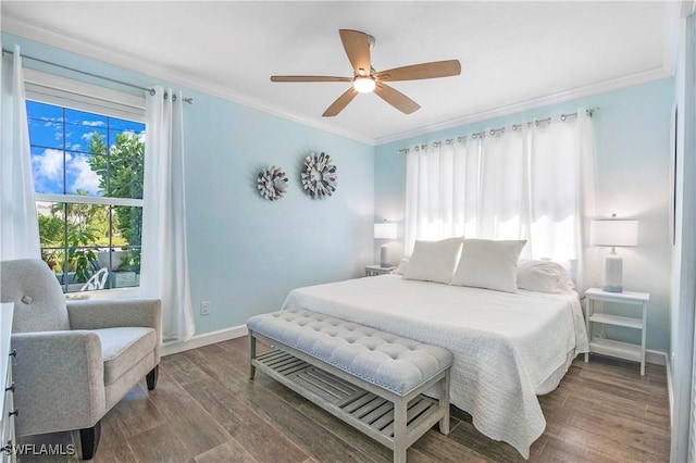 bedroom with ceiling fan, dark hardwood / wood-style floors, and ornamental molding