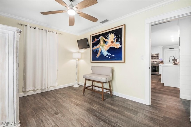 living area with ceiling fan, crown molding, and dark wood-type flooring