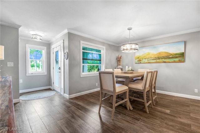 dining space featuring crown molding, dark hardwood / wood-style flooring, and a notable chandelier