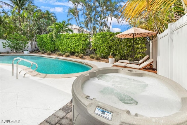 view of swimming pool featuring an outdoor hot tub