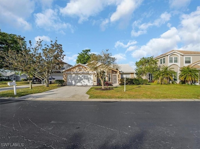 view of front of house with a garage and a front yard