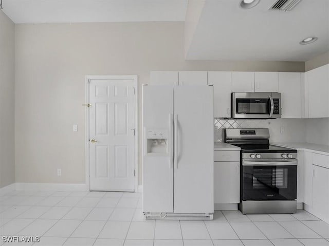 kitchen featuring backsplash, white cabinetry, light tile patterned flooring, and stainless steel appliances