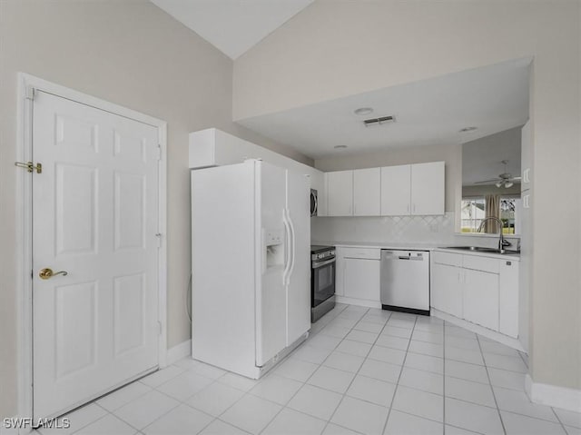 kitchen with white cabinets, sink, ceiling fan, light tile patterned flooring, and stainless steel appliances