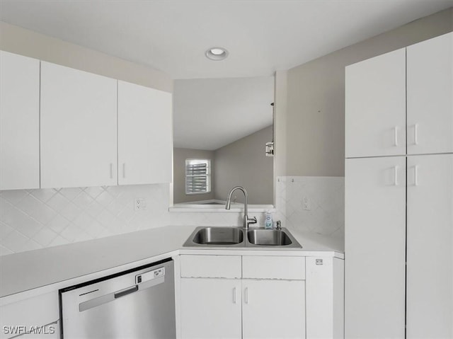 kitchen with white cabinets, backsplash, stainless steel dishwasher, and sink