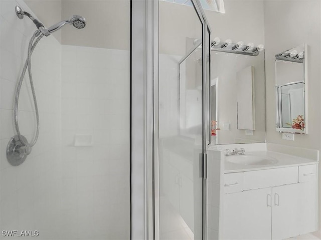 bathroom featuring vanity and a shower with shower door