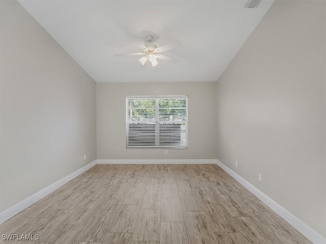 empty room with ceiling fan and light hardwood / wood-style flooring