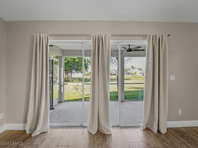 entryway with wood-type flooring and ceiling fan