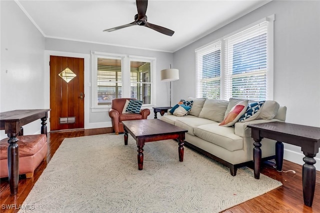 living room with plenty of natural light, wood-type flooring, and ornamental molding