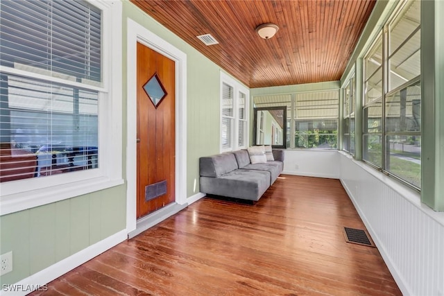 unfurnished sunroom with wood ceiling