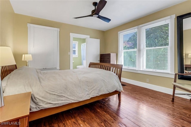 bedroom featuring ensuite bath, ceiling fan, and dark wood-type flooring