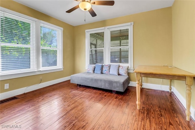 living area featuring ceiling fan and wood-type flooring