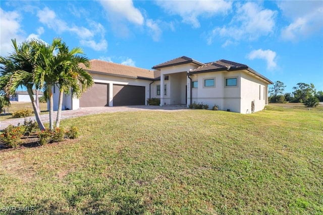 view of front of home featuring a garage and a front lawn