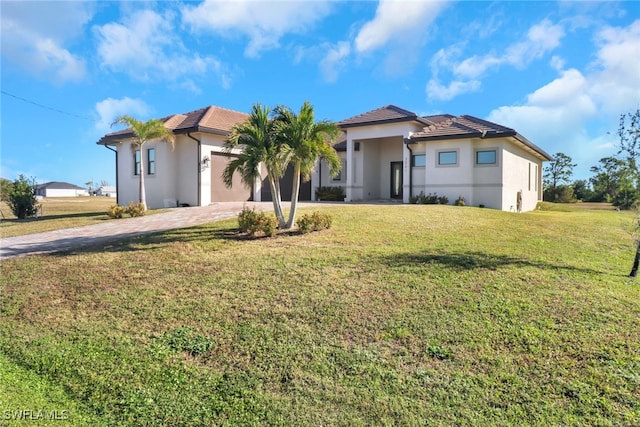 view of front of house with a front yard and a garage