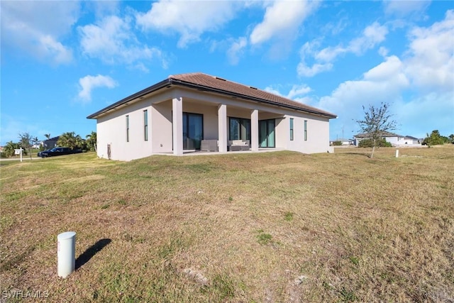 rear view of property with a yard