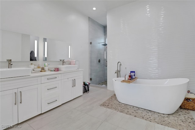 bathroom with vanity and separate shower and tub