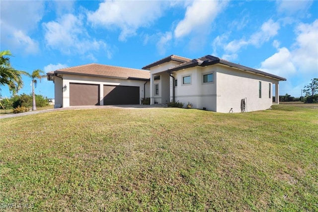 view of front of home with a front lawn and a garage