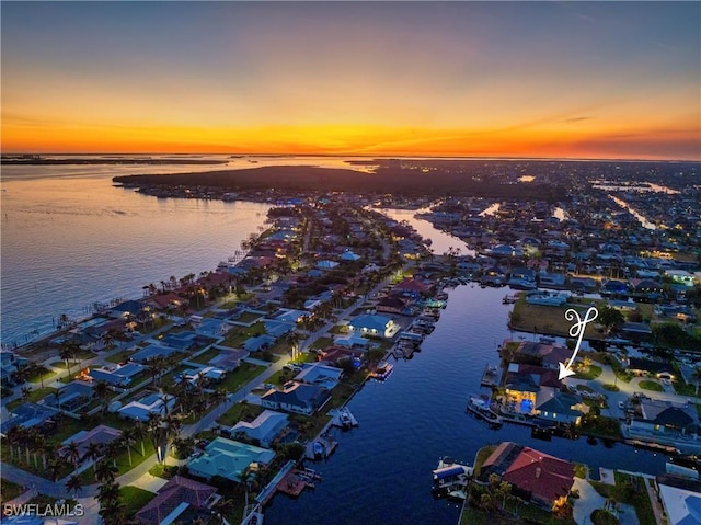 aerial view at dusk with a water view