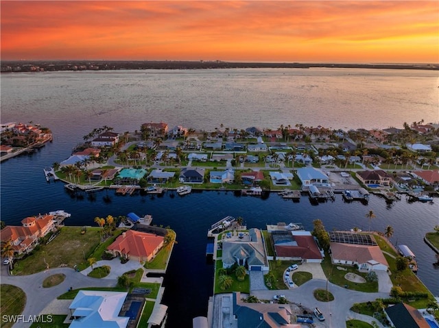 aerial view at dusk with a water view